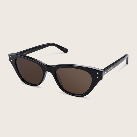 Black cat-eye sunglasses with dark lenses on a beige background