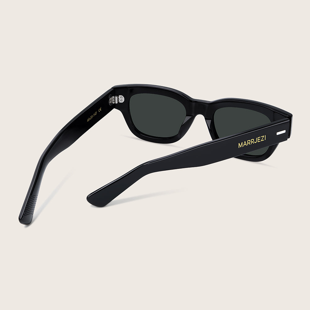 Black sunglasses with 'MARRJEZI' branding on a beige background