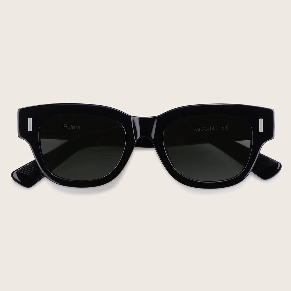 Black sunglasses with a brand logo on a light beige background
