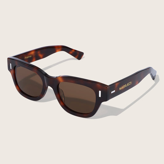 Sunglasses with tortoiseshell frame and brown lenses on a beige background