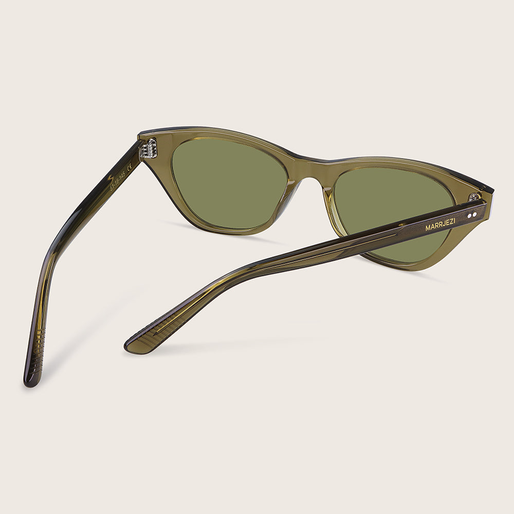 Sunglasses with green lenses and brown frame on a beige background