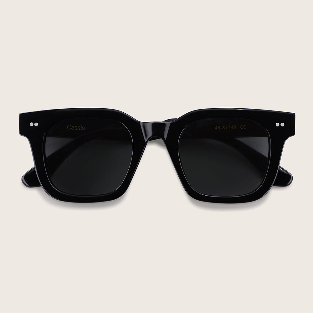 Black sunglasses on a beige background