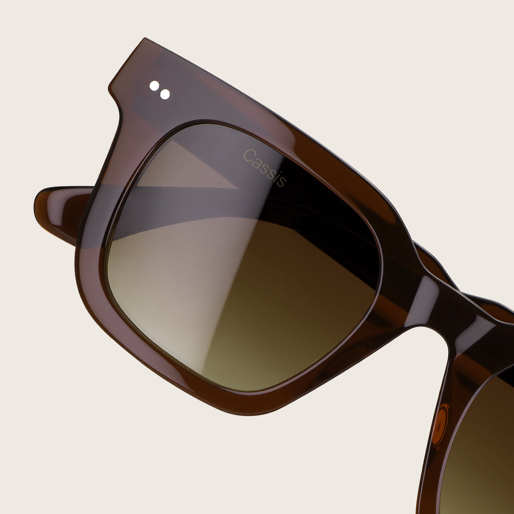 Brown sunglasses with a reflective surface on a beige background
