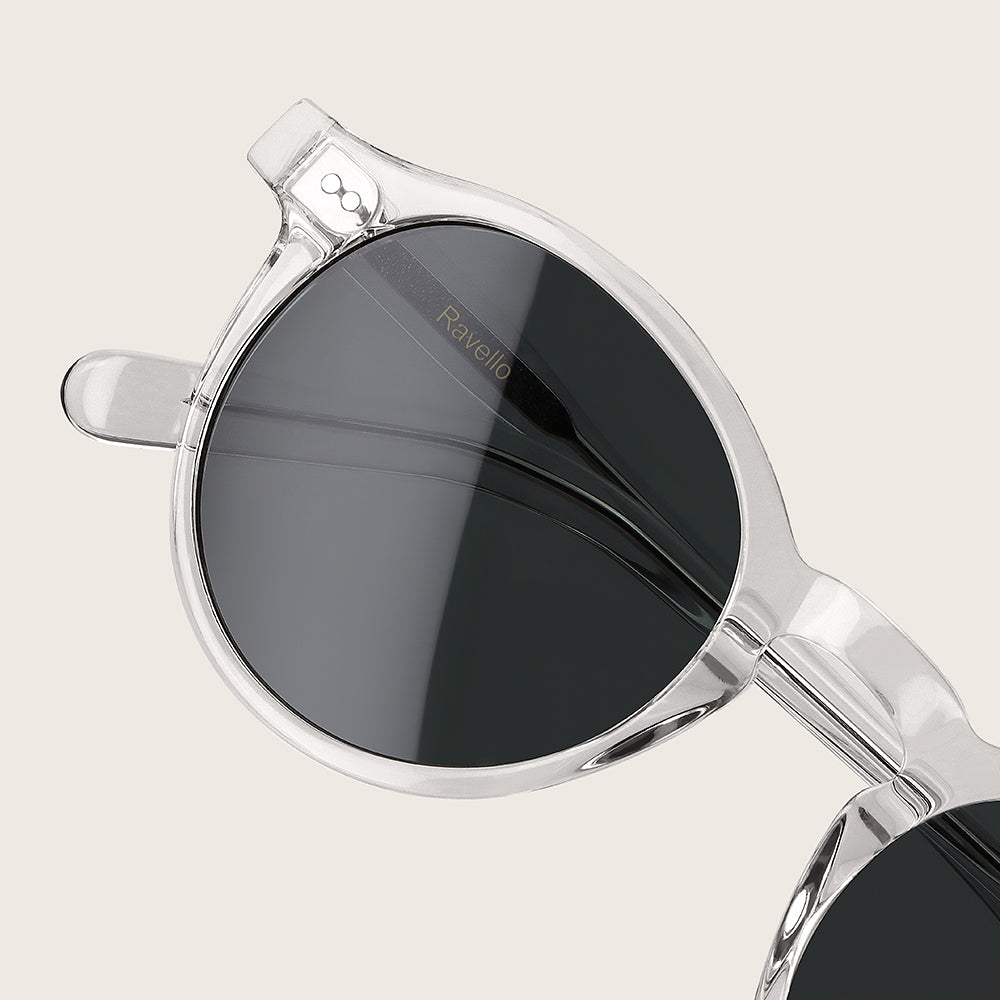 Silver-framed sunglasses with black lenses on a light gray background