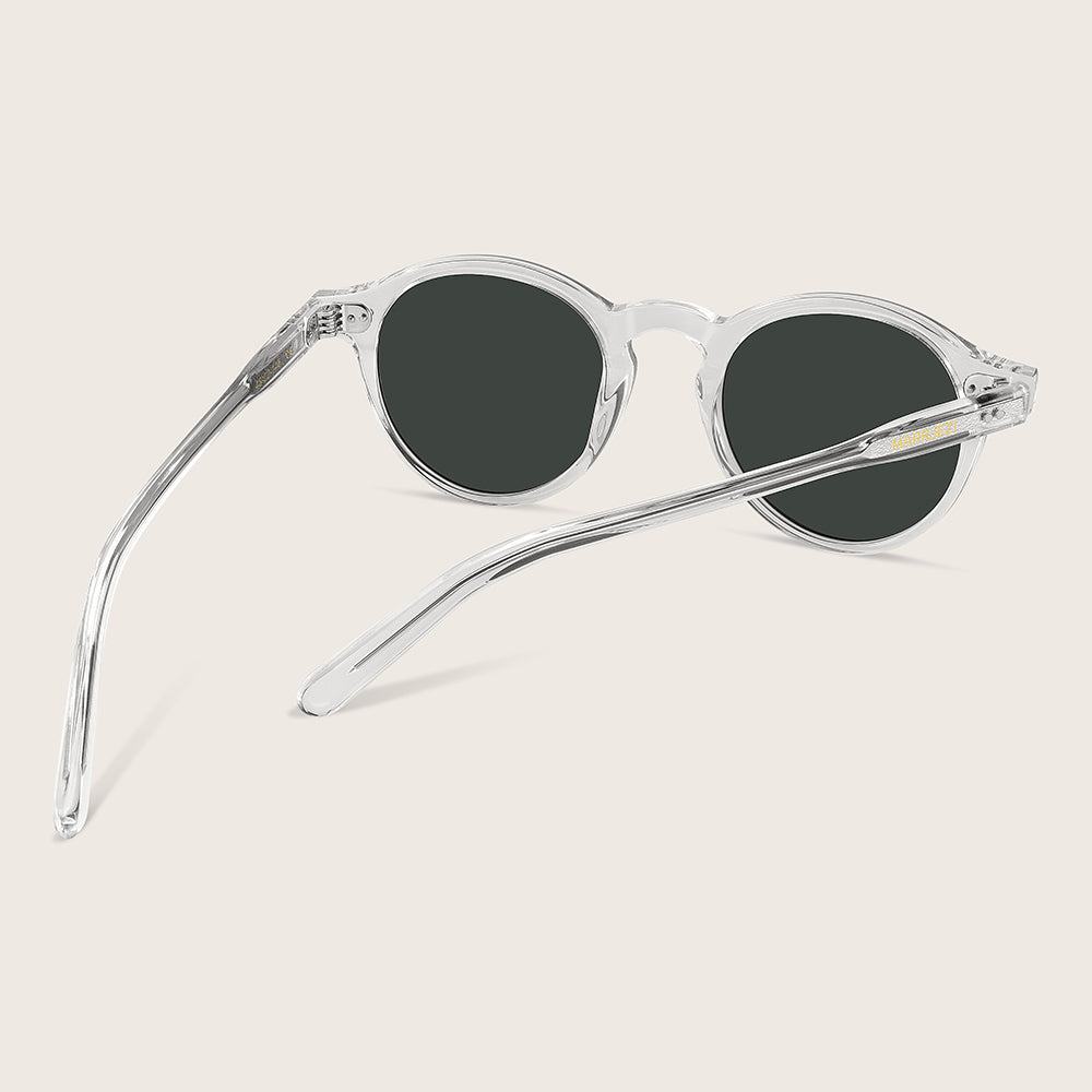 Clear frame sunglasses with dark lenses on a light gray background