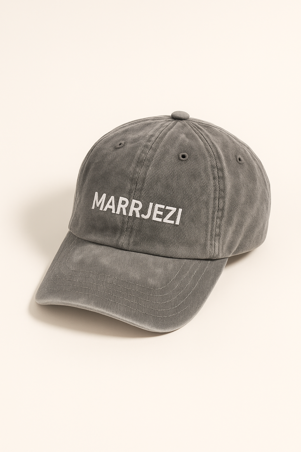Unisex grey cotton cap, stonewashed with soft texture — 3/4 angle shows classic curved brim and adjustable fit
