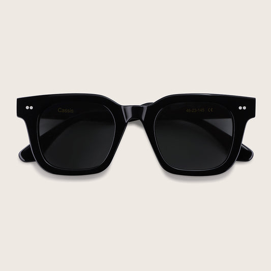 Black sunglasses on a beige background