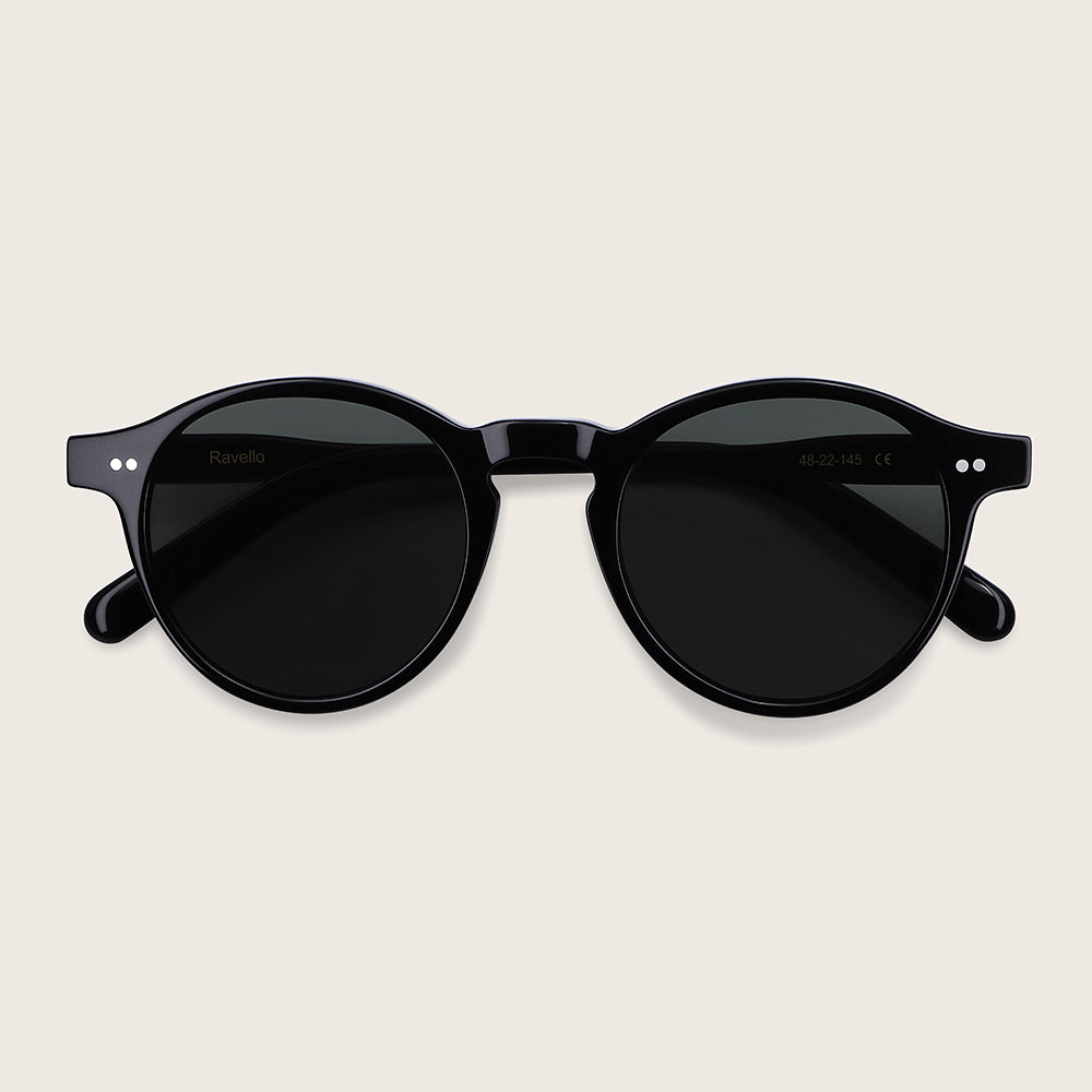 Black sunglasses on a light beige background